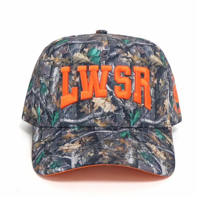 Woodlands L Hat front view — real tree camo snapback with puff embroidered LWSR in orange by The Lewwsers